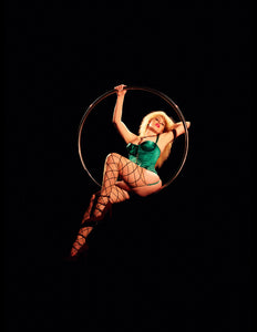 Close up of woman wearing the Emerald Garden Corset sat on a showgirl hoop