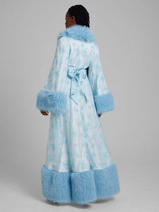 Women wearing blue arctic gown dressing robe with fur trim from behind