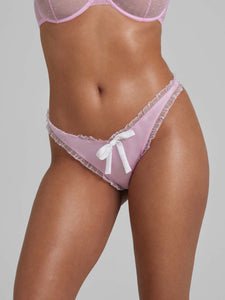 Close up of woman wearing pink thong with white bows
