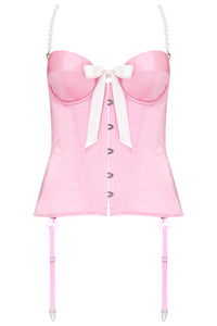 Pink corset with white bows, pearl detailing, and suspender straps